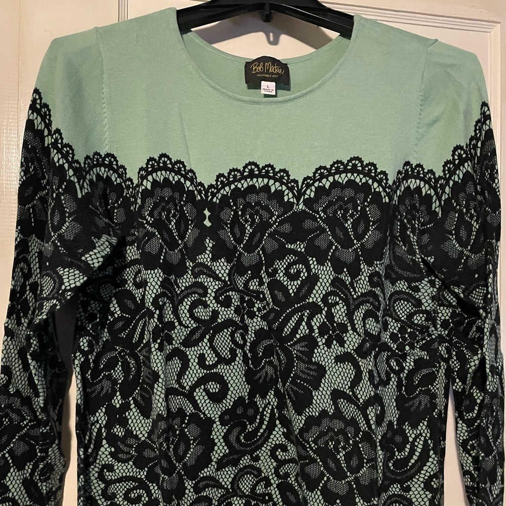 Bob Mackie Women’s sweater, light green with black lace print.